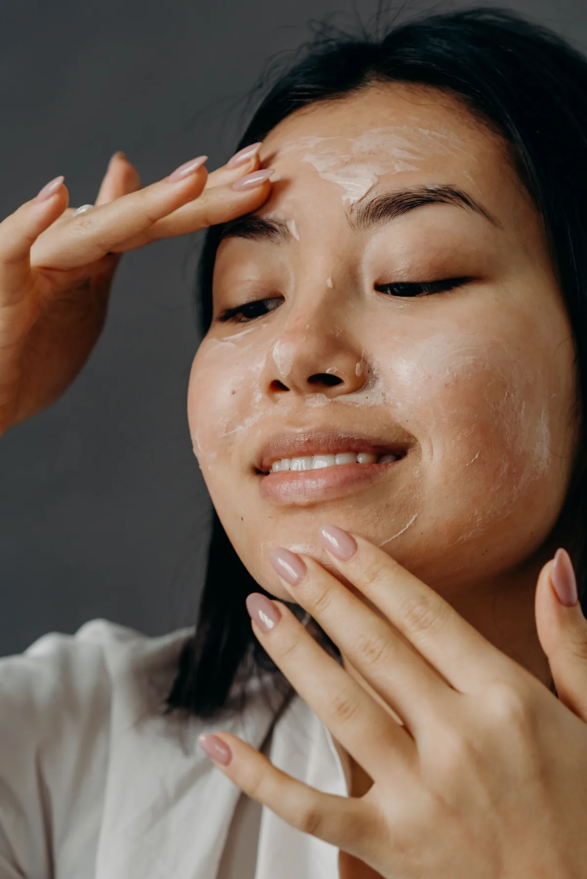 Woman applying a facial skincare treatment